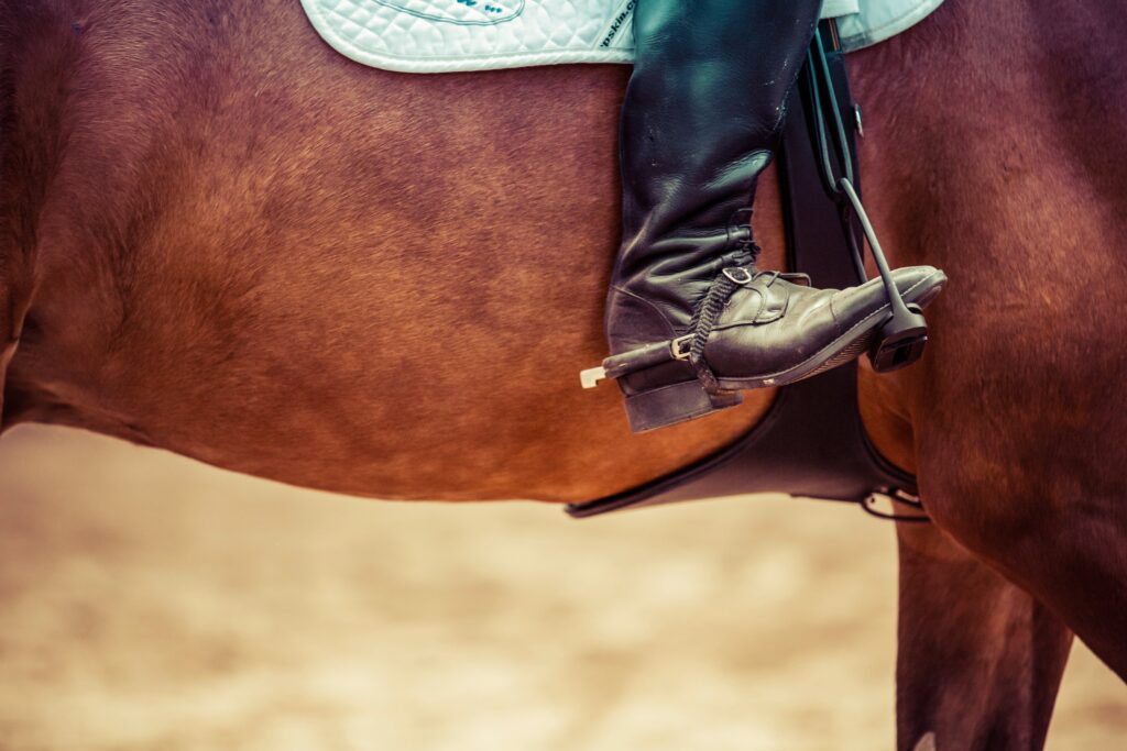 someone wearing english riding spurs over a boot